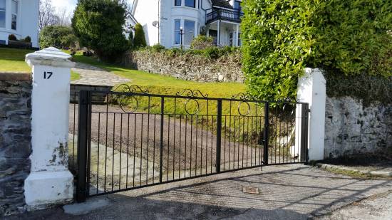 Bi - Fold gates made to slope of ground